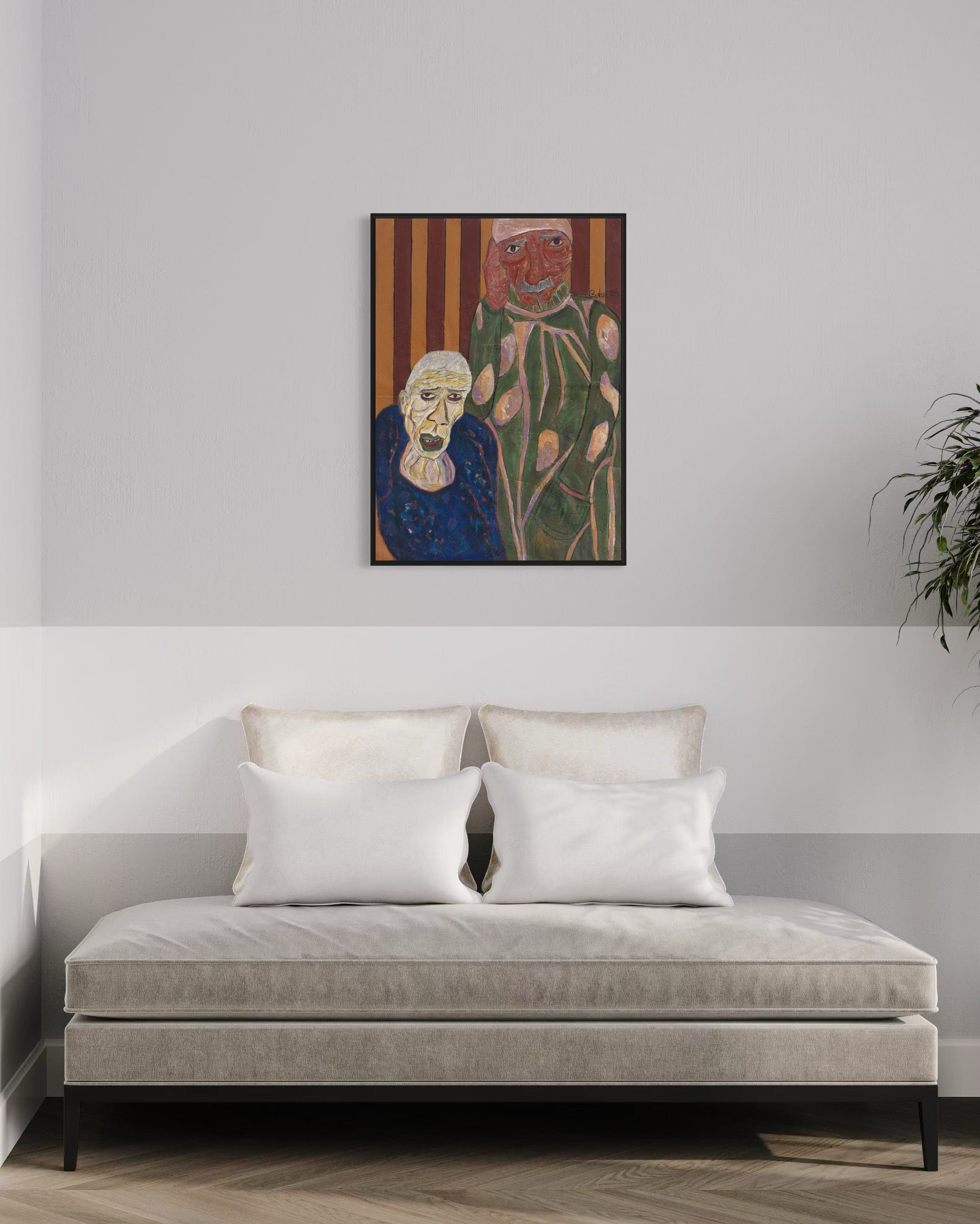 Framed artwork above a sofa in a room with a plant