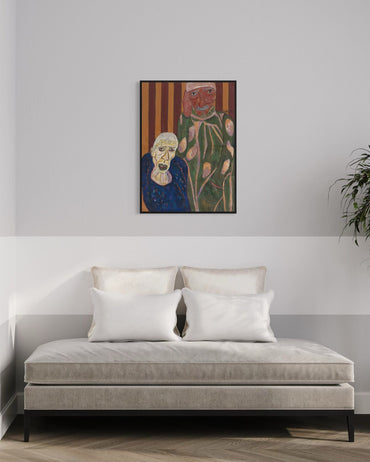 Framed artwork above a sofa in a room with a plant