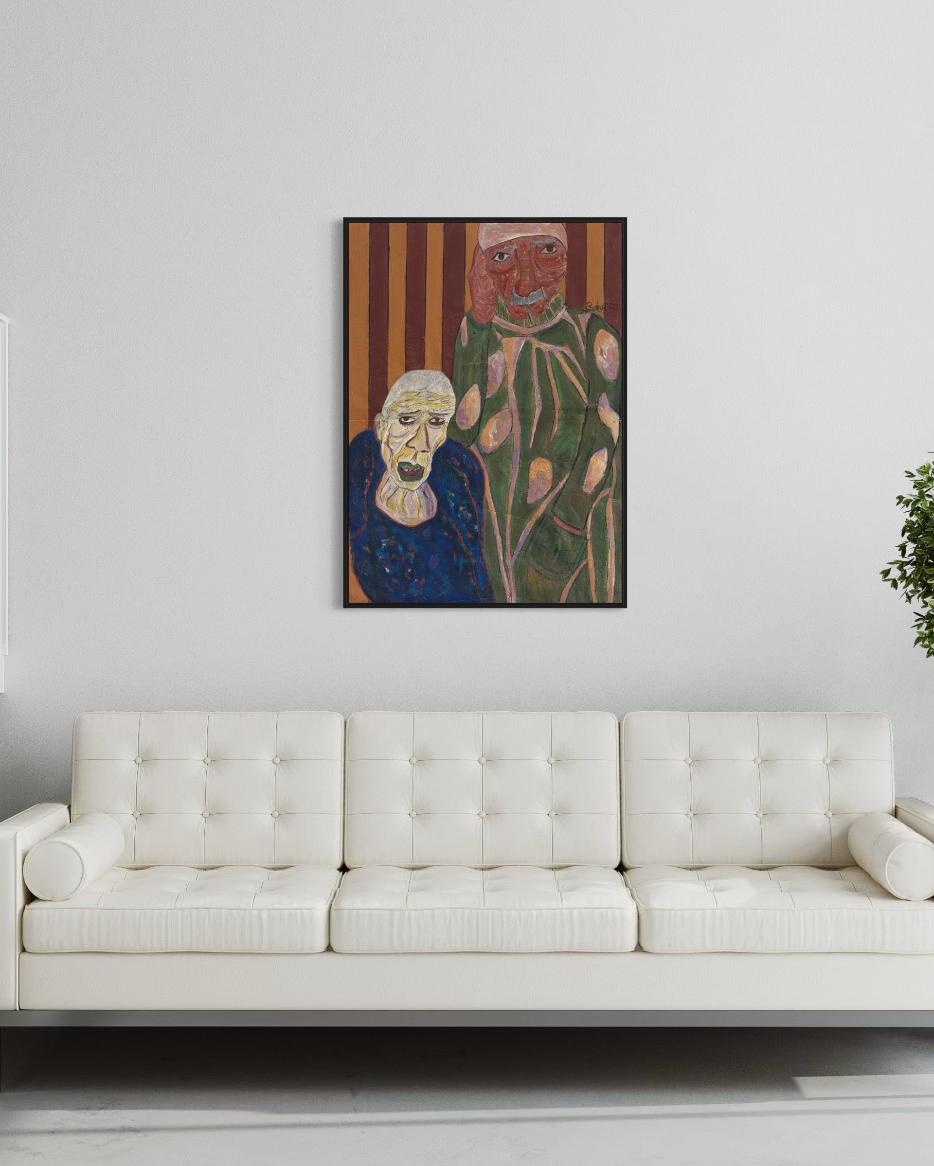 Framed artwork of an elderly woman and a floral figure on a white wall above a white sofa.