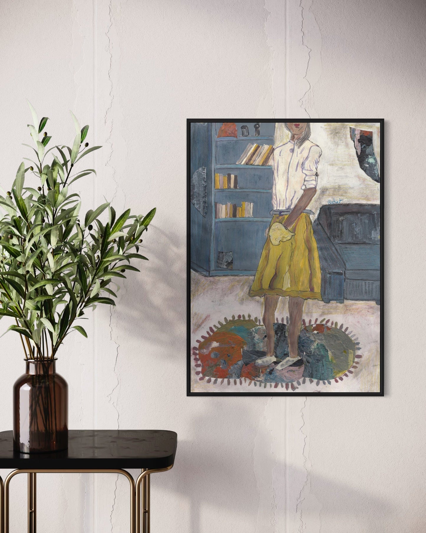 Framed artwork of a person in a yellow skirt standing in a room with books and a plant on a table.
