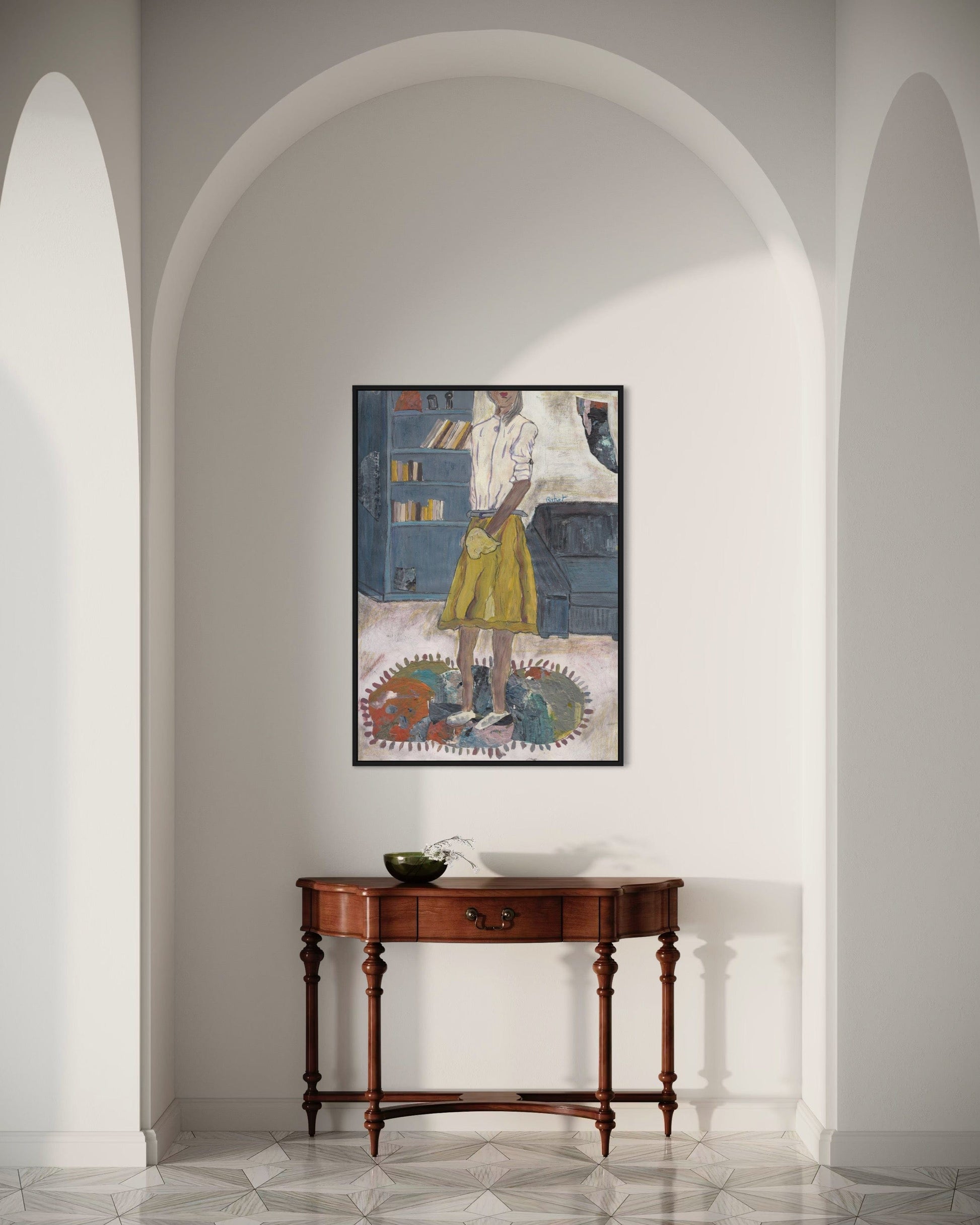 Framed artwork on a wall above a wooden console table in a room with arched doorways.
