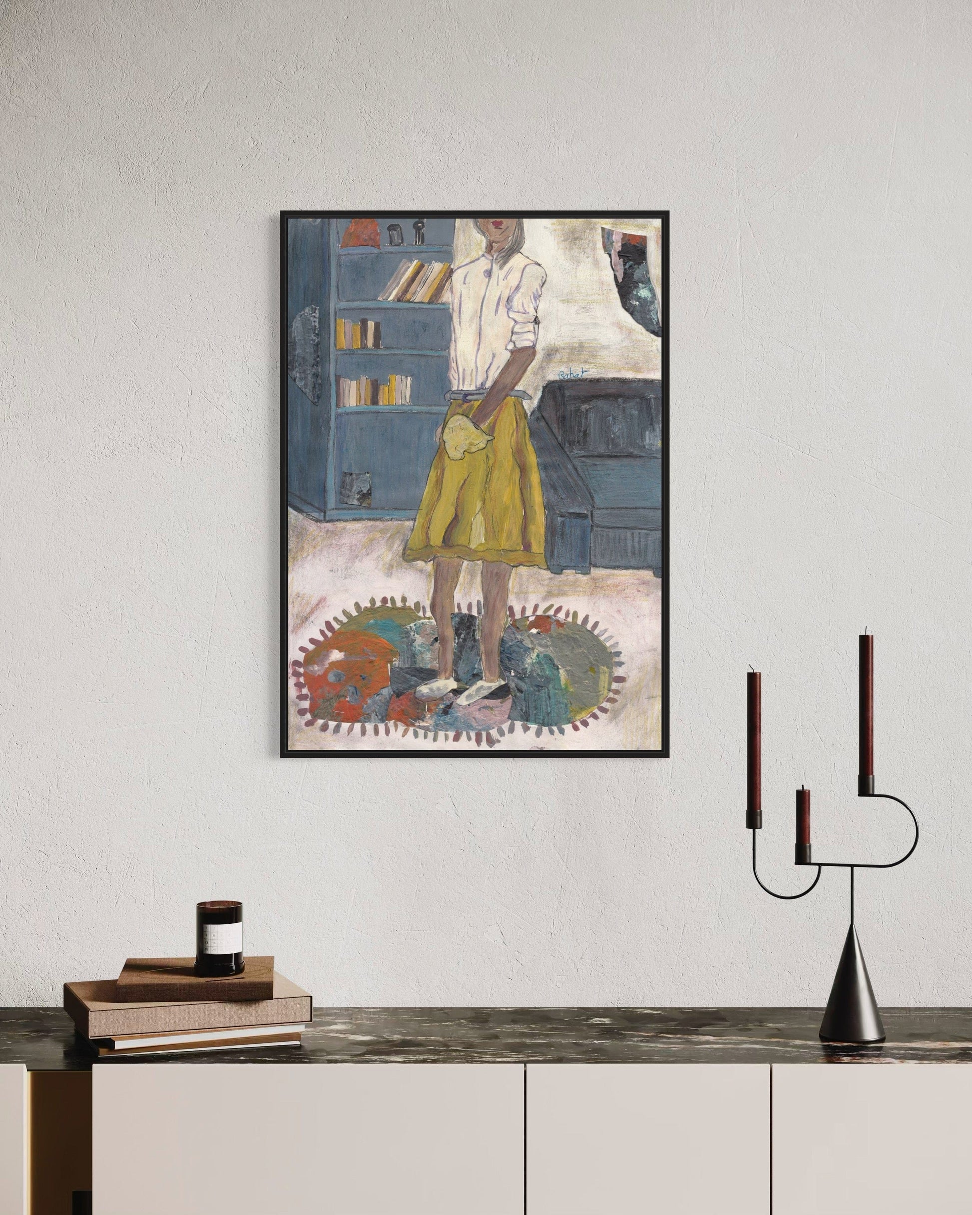 Framed artwork on a wall above a console table with decorative items.