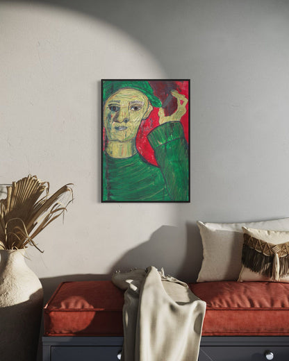 Framed artwork of a stylized portrait on a wall above a sofa in a living room.