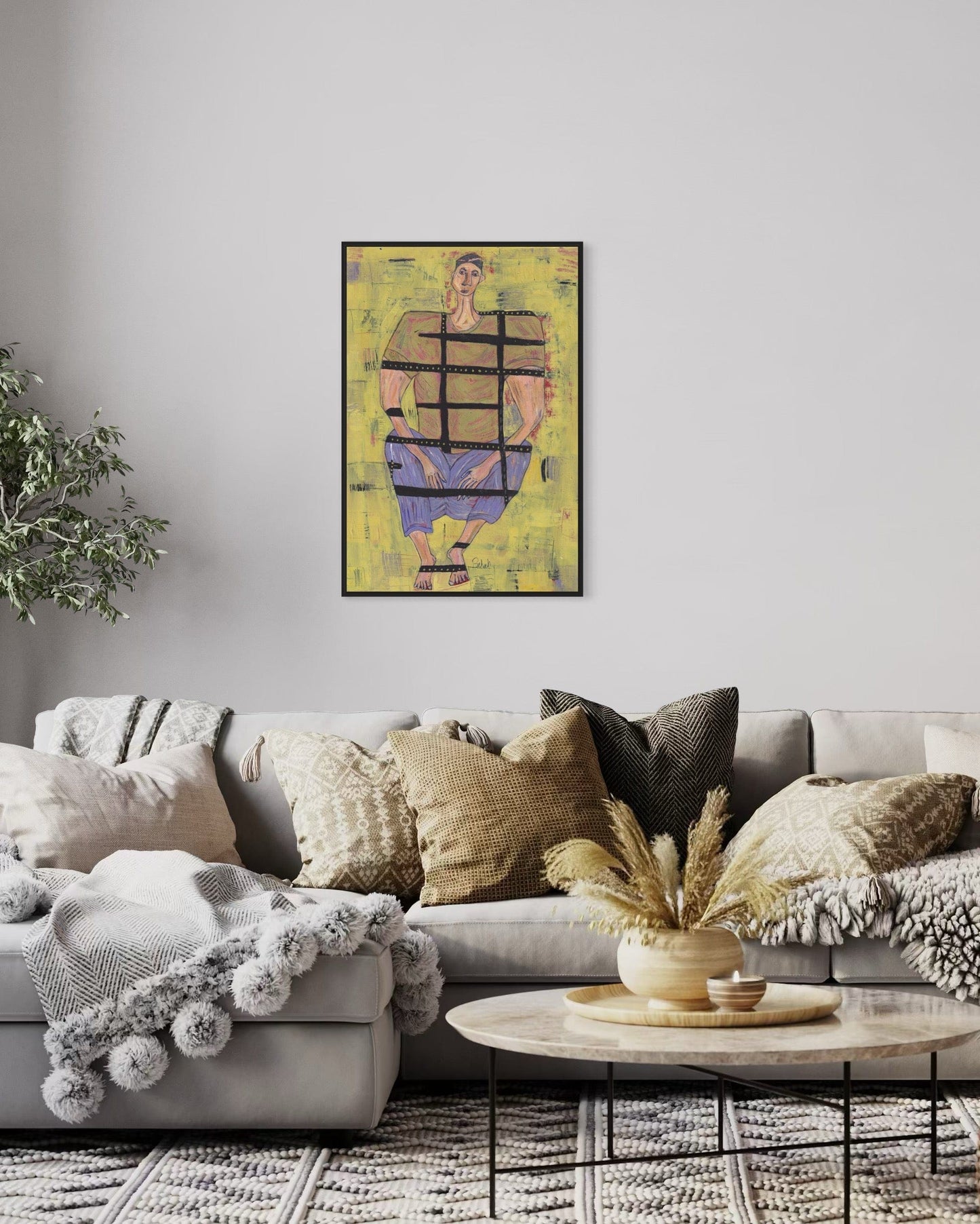 Living room with a gray sofa, decorative pillows, and a framed artwork on the wall.