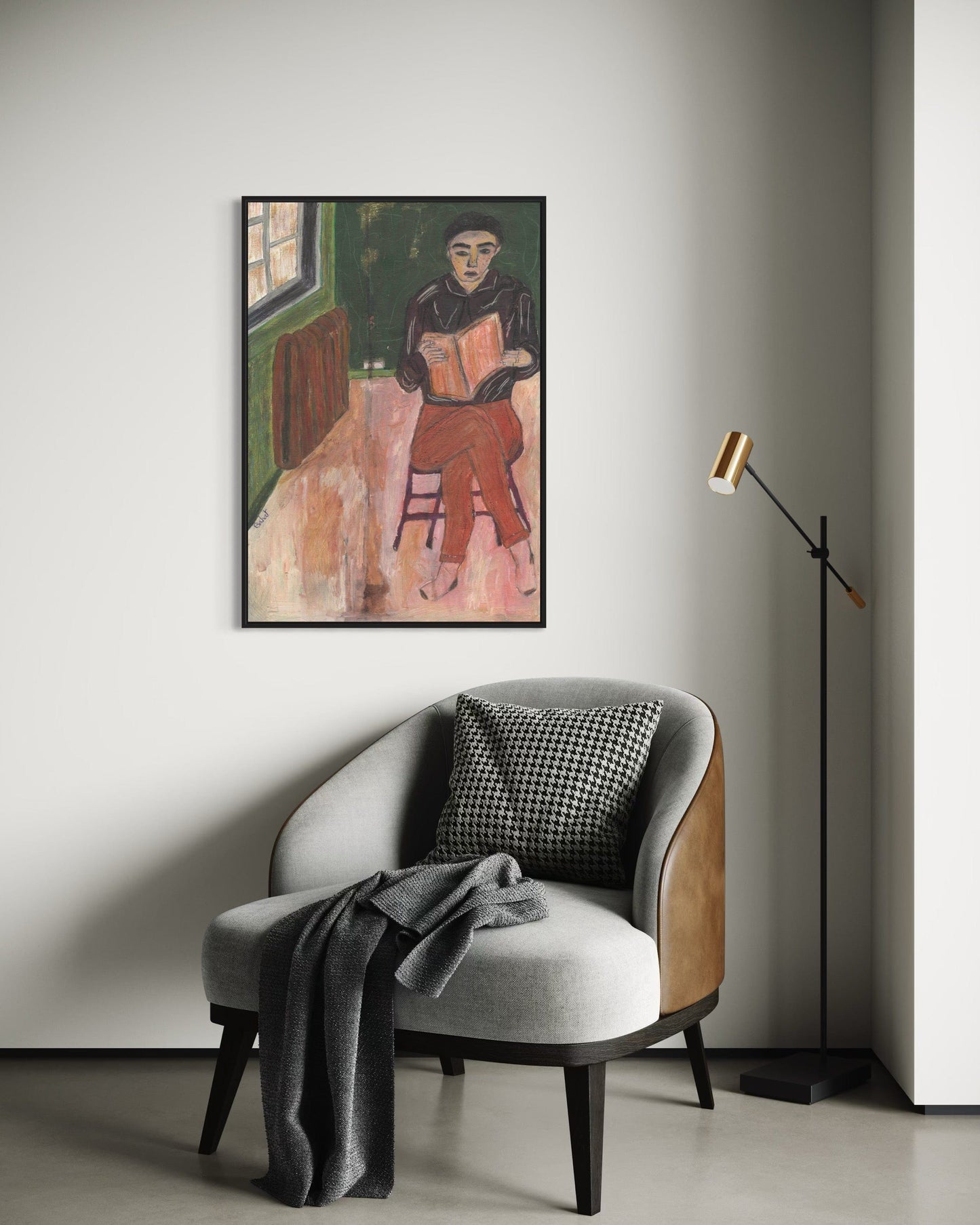 Framed artwork on a wall above a modern chair with a lamp in a minimalistic room.