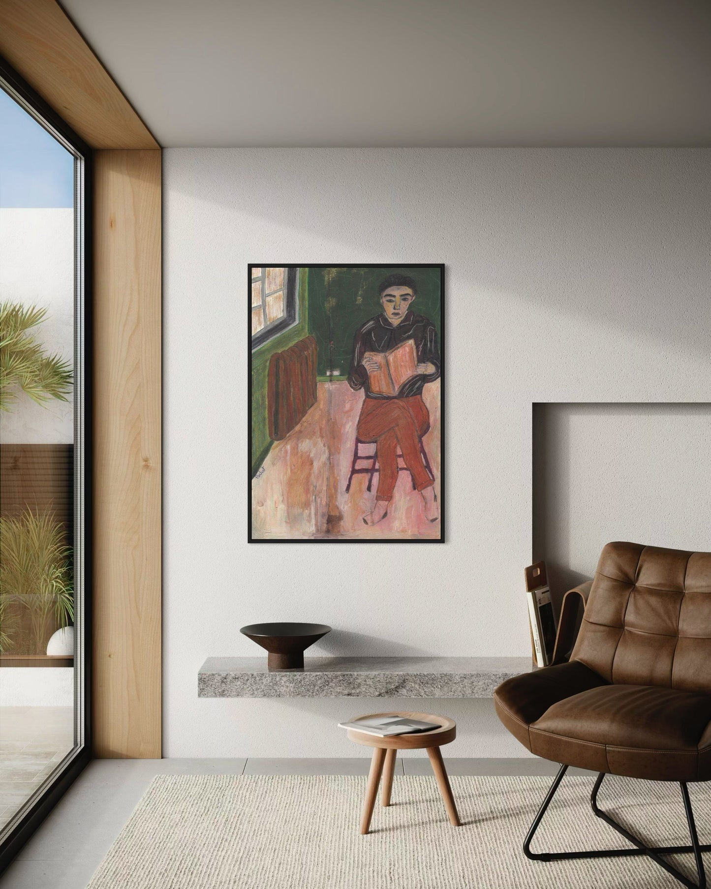 Modern living room with a framed artwork on the wall, a brown leather chair, and a small table.