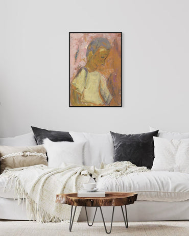 Framed abstract art above a white sofa with black and gray pillows in a living room setting.