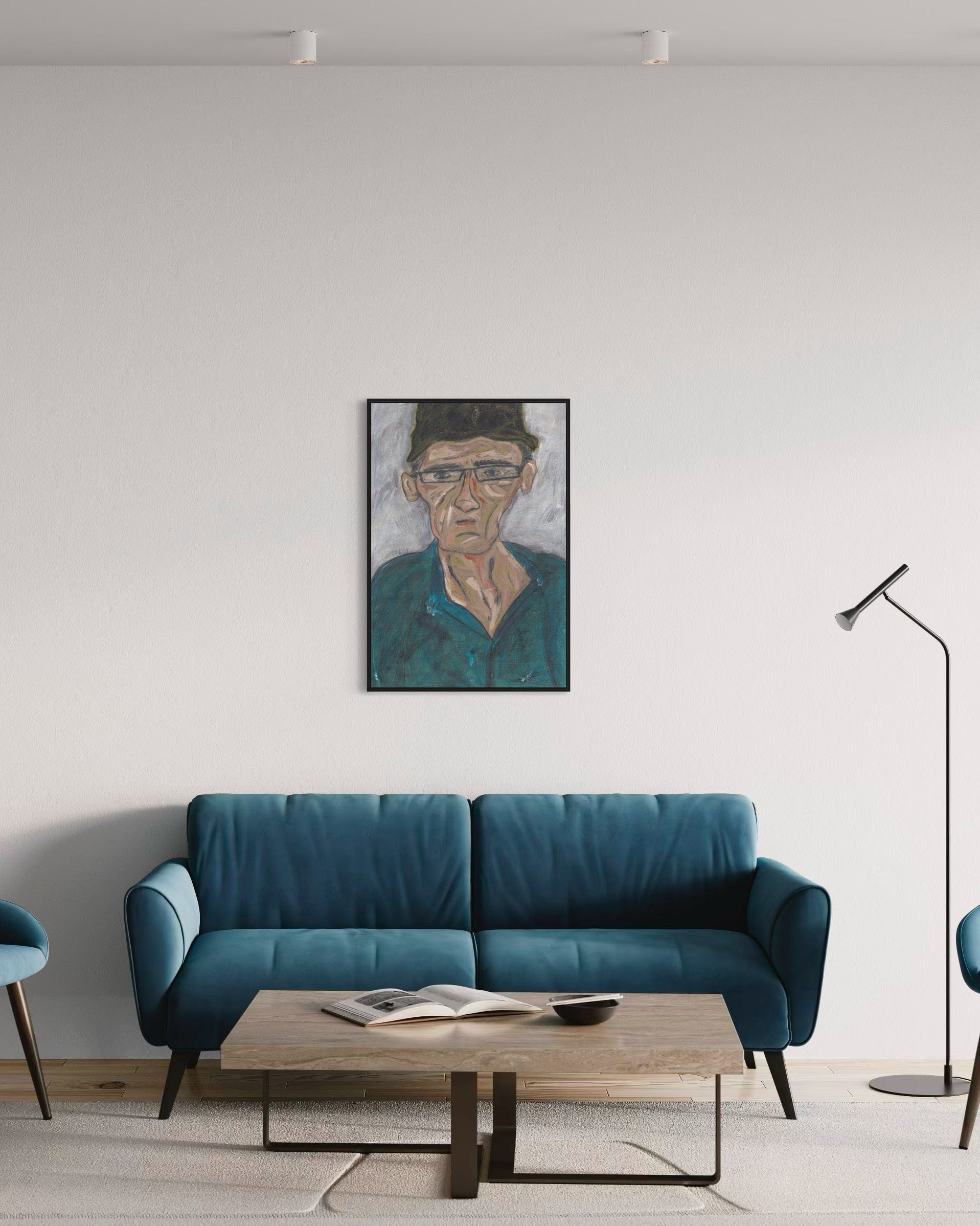 Modern living room with a blue sofa, wooden coffee table, and framed portrait on the wall.