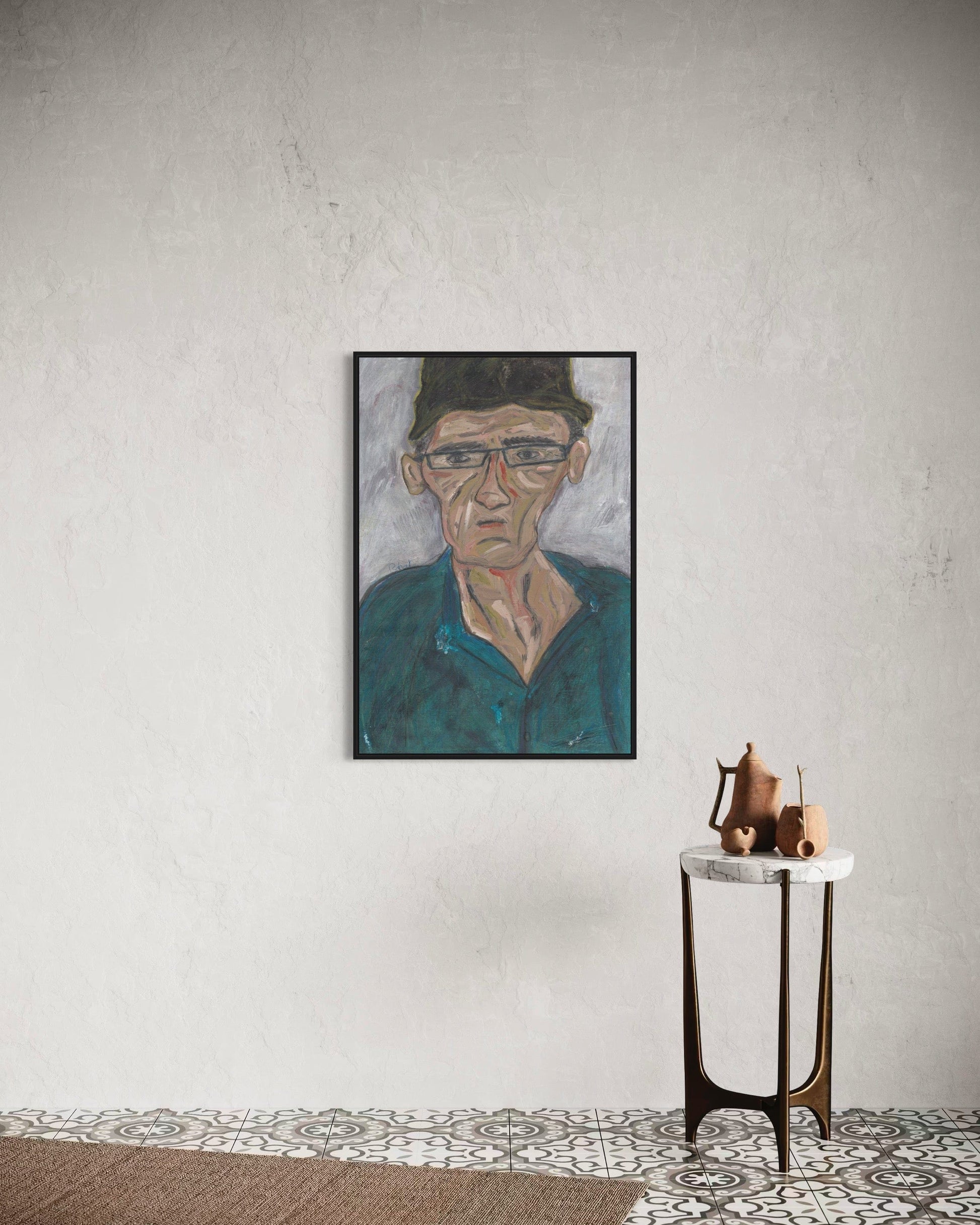 Framed portrait on a wall above a small table with decorative items.
