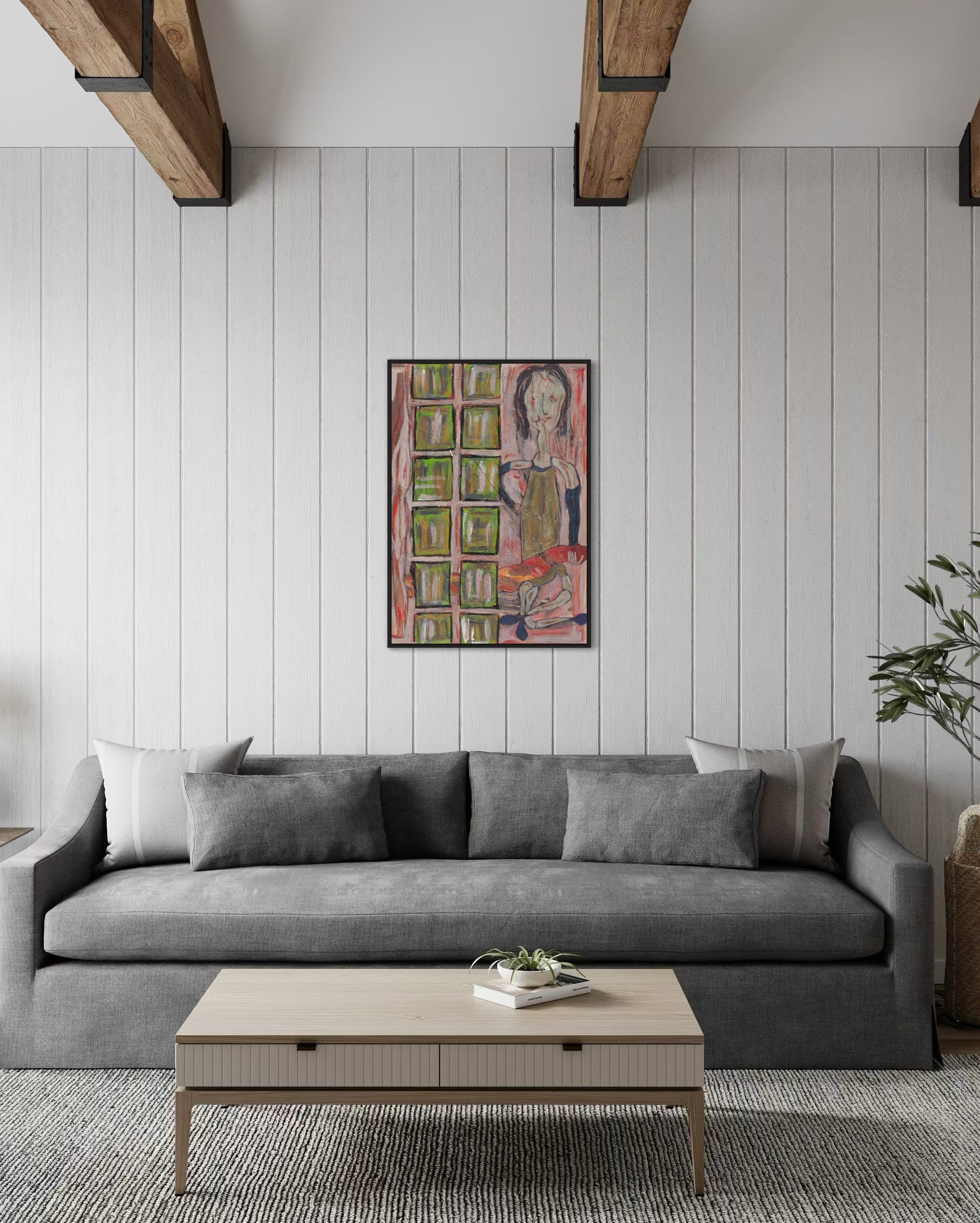 Gray sofa in a living room with a colorful painting on the wall.