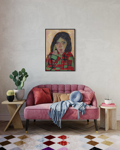 Living room with a pink sofa, colorful rug, and framed artwork on the wall.