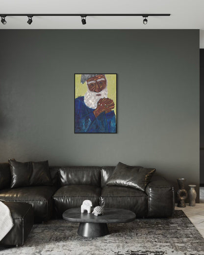 Living room with a black leather sofa, round coffee table, and a painting of an elderly man on the wall.
