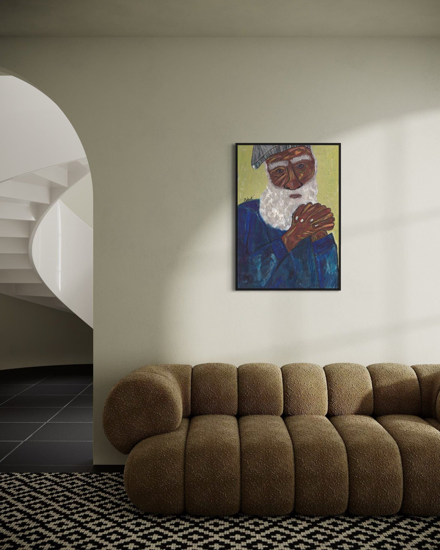 Brown sofa in a room with a wall painting of an elderly man.