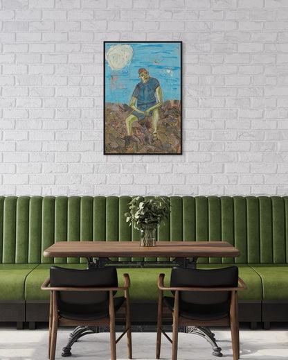 Green booth with wooden table and chairs against a white brick wall with a framed painting.