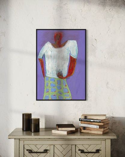 Framed abstract art on a wall above a wooden cabinet with books.