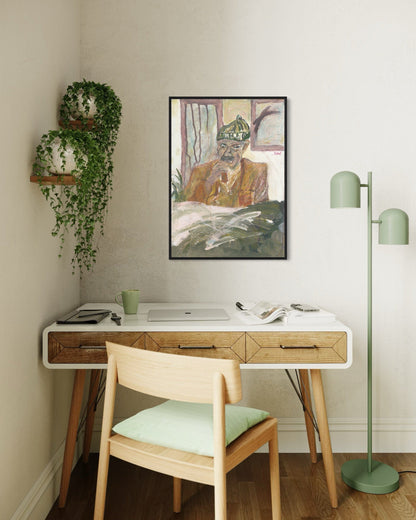 Home office with a desk, chair, lamp, and wall art.