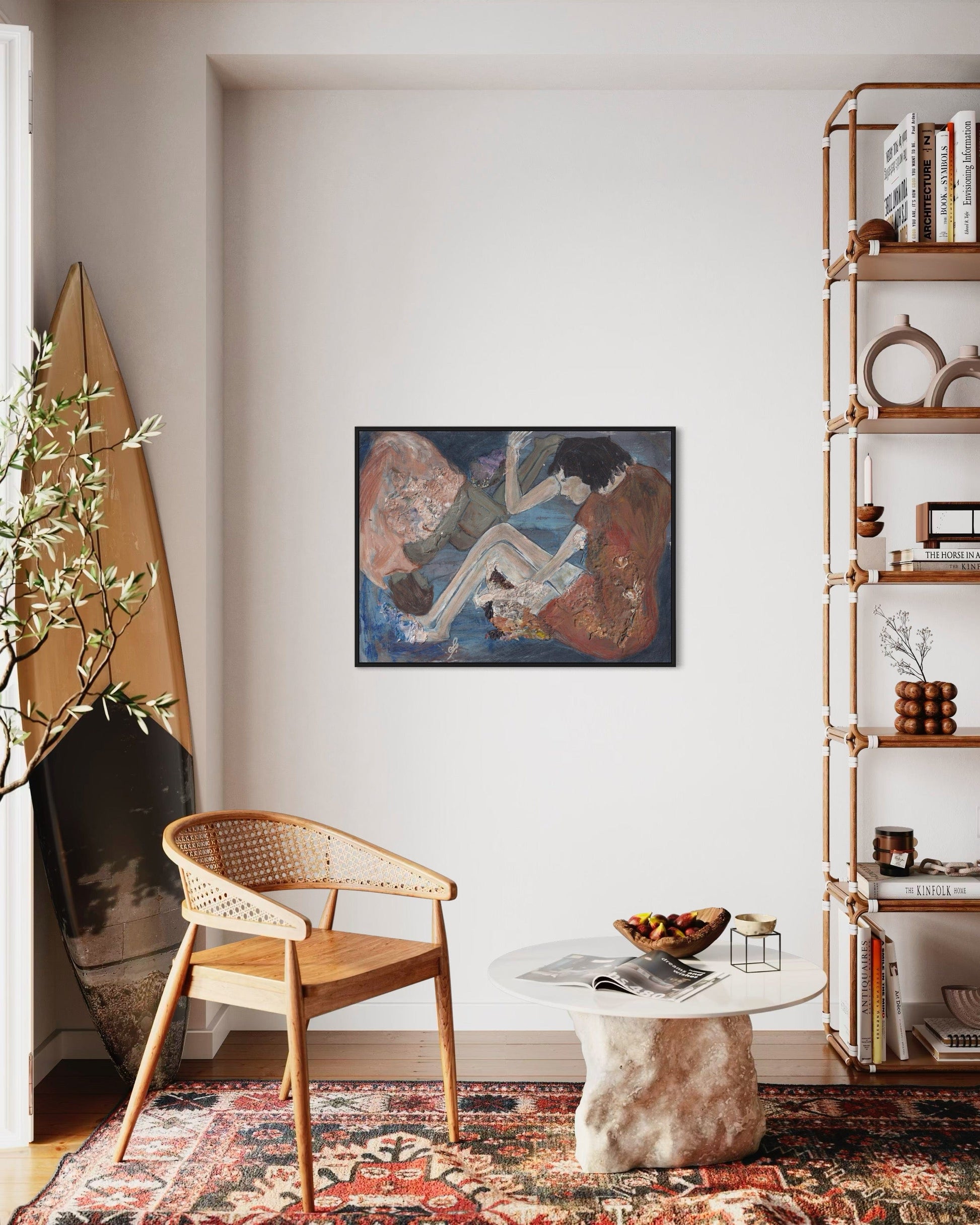 Living room with a wicker chair, round table, and bookshelf.