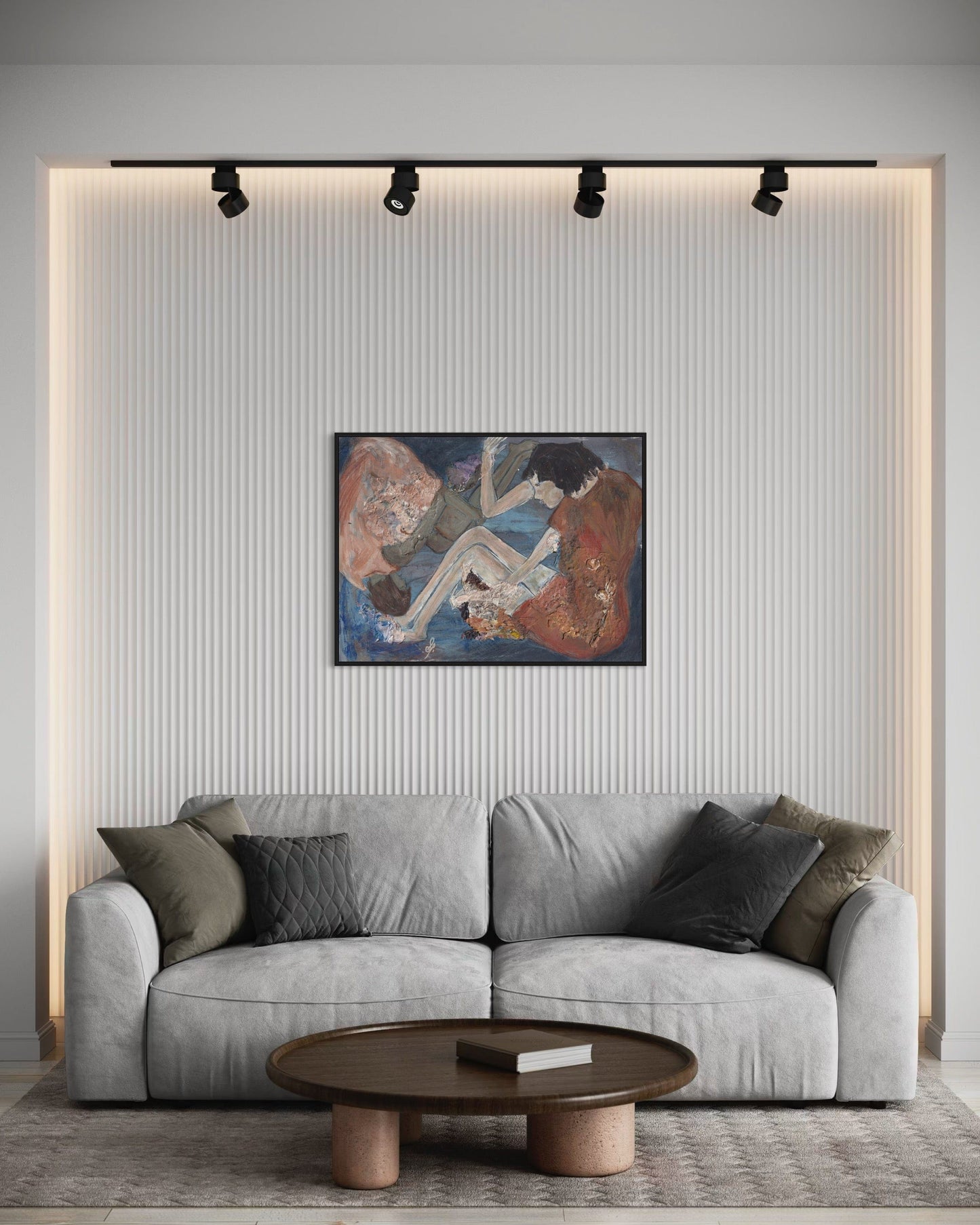 Gray sofa in a living room with a painting on the wall and a wooden coffee table.