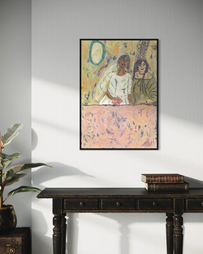 Framed artwork on a wall above a dark wooden console table with books and a plant.