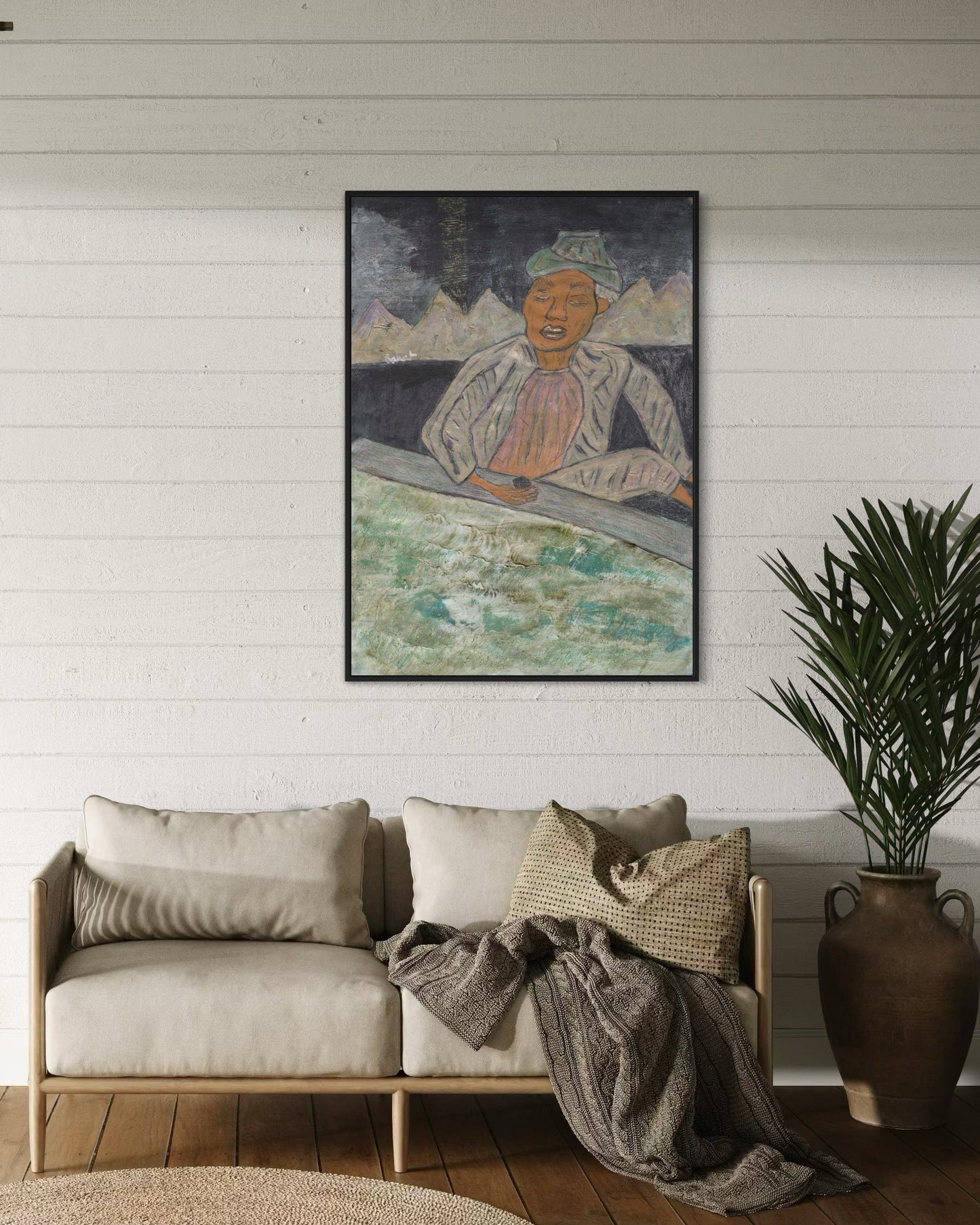 Living room with a beige sofa, decorative pillows, and a framed artwork on the wall.