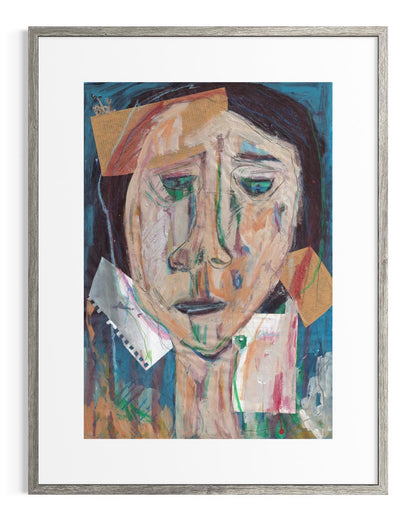 Framed abstract artwork of a face with colorful blocks on a white background