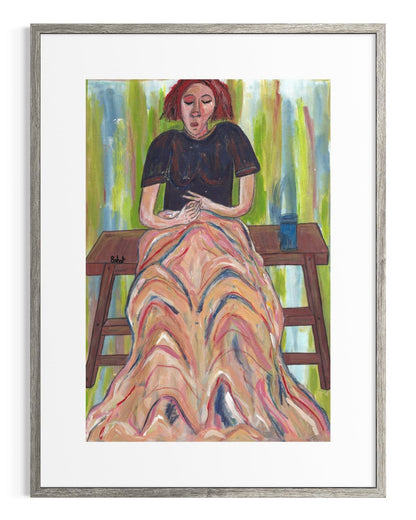 Framed artwork of a woman sitting on a bench with a colorful dress.