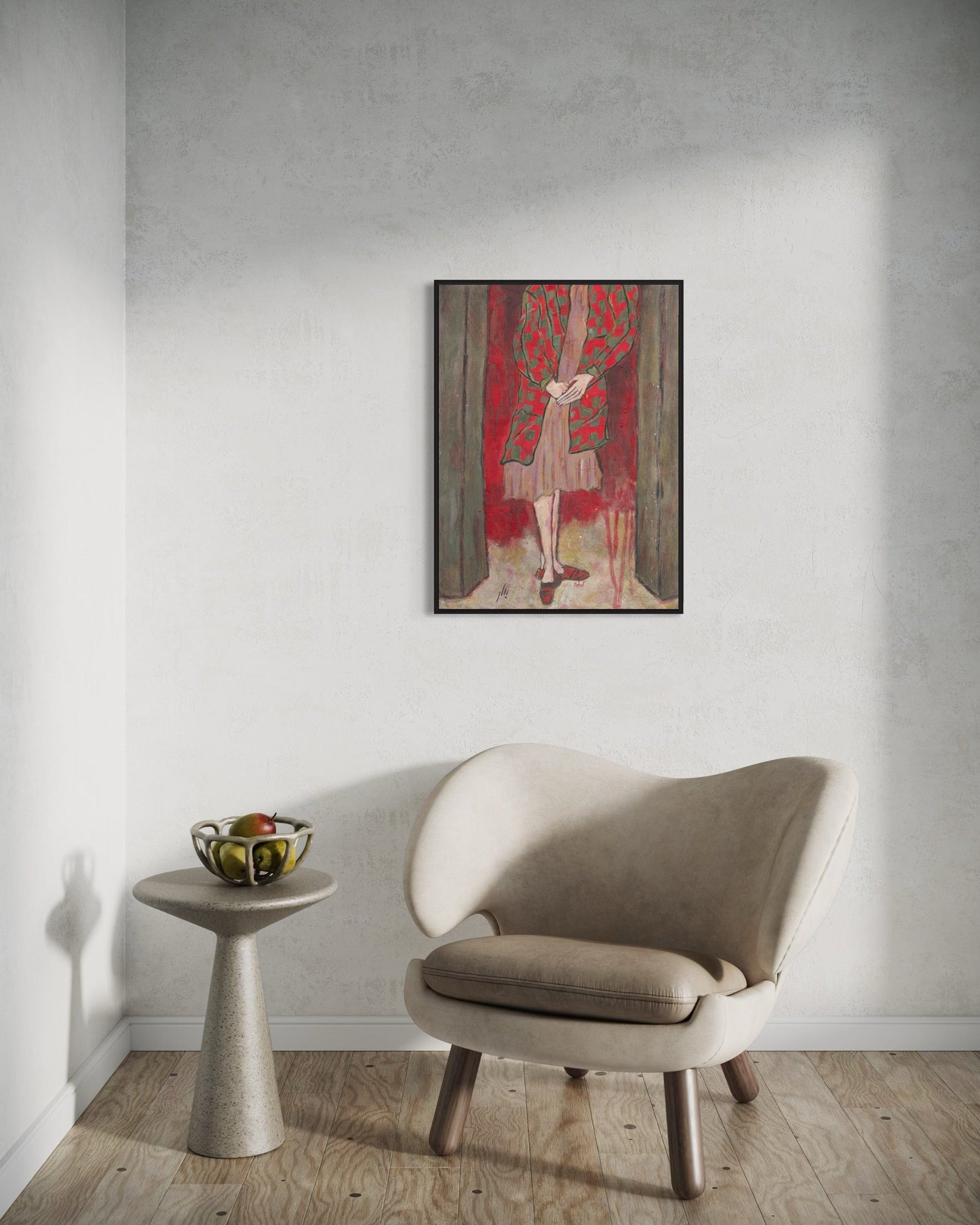 Beige armchair in a room with a wall painting and small table.