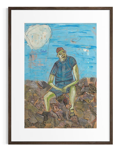 Framed artwork of a person sitting on rocks with a blue sky and moon in the background.